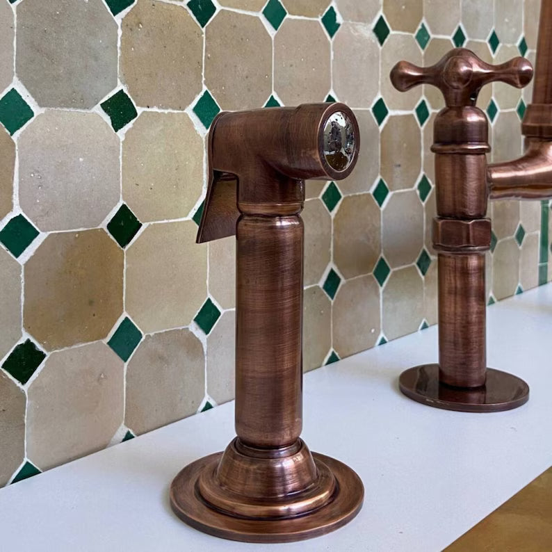Modern Copper Kitchen Faucet – Handcrafted with warm vintage finish, mounted on a white countertop against a tiled green and beige backsplash.