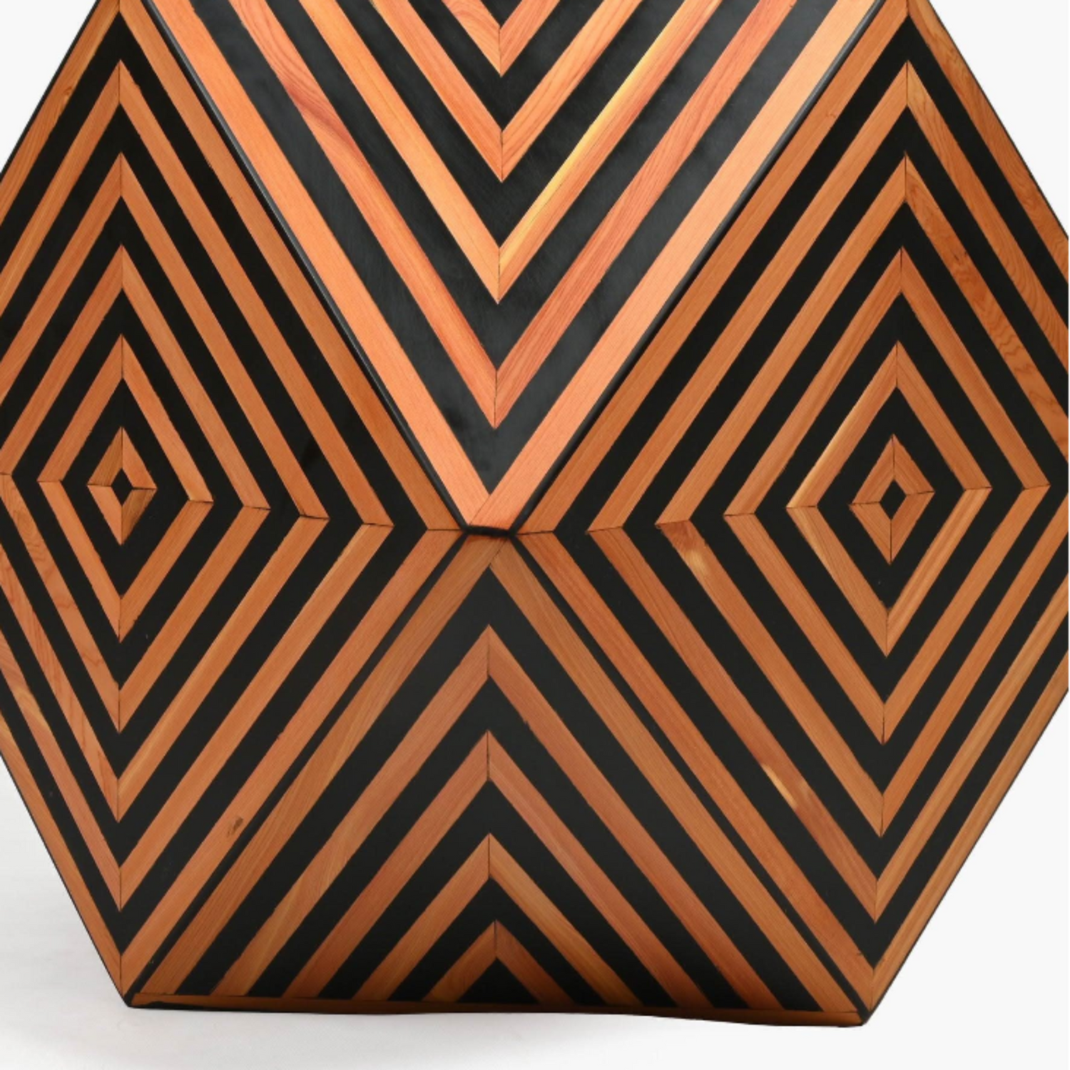 Hexagonal clutch bag with black and orange geometric pattern on a white background