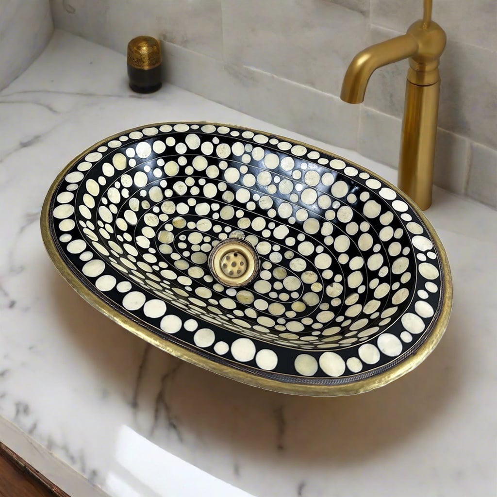 Side angle of a custom-made brass drop-in sink showcasing its depth, detailed mosaic inlay, and polished brass trim, highlighting artisanal craftsmanship