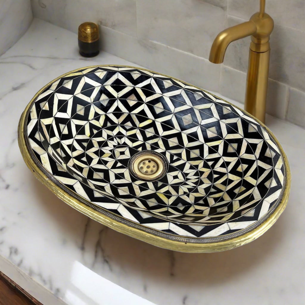 Close-up of the artisanal bathroom basin showing detailed brass, resin, and bone inlay work, highlighting the craftsmanship and luxurious design