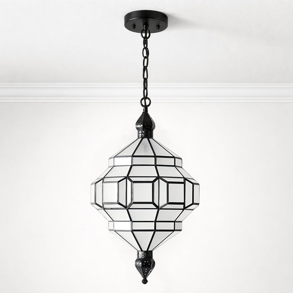 Ornate Moroccan-style pendant light with clear glass panels and a black metal geometric frame, suspended from the ceiling by a black chain