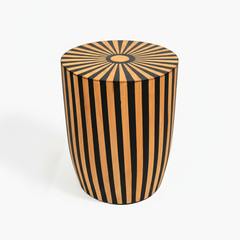 Wooden stool with black and gold striped pattern on a white background