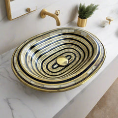Top view of handcrafted brass sink with resin and bone inlay, showcasing intricate Moroccan design and polished brass finish