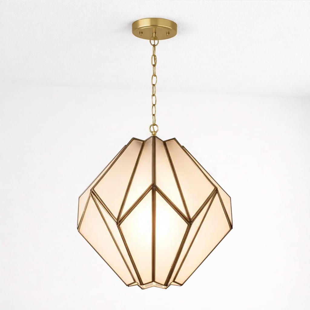 Geometric pendant light with frosted glass panels and a gold brass frame, suspended from a white ceiling by a matching chain