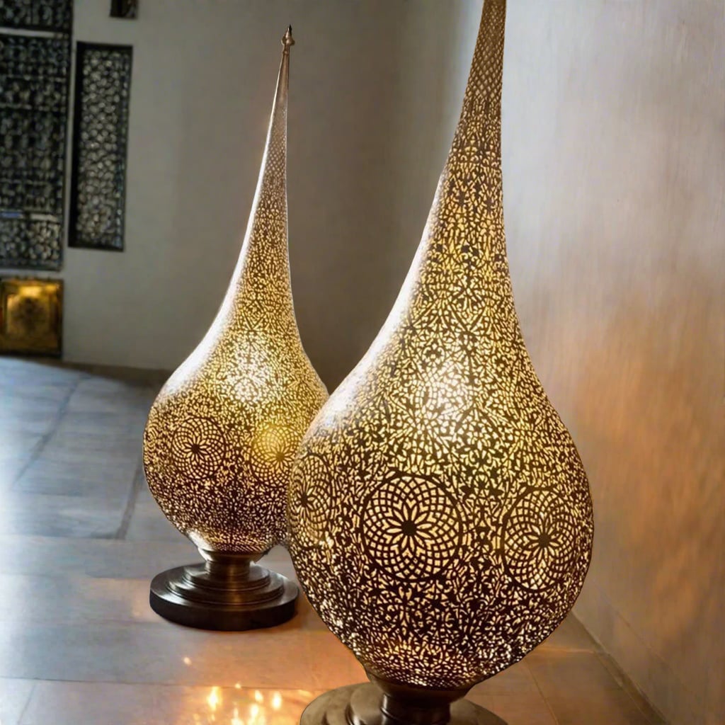 Pair of handcrafted Moroccan brass floor lamps with intricate hand-pierced patterns casting warm ambient light in a living room setting