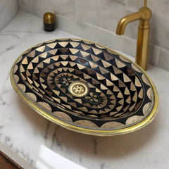 Close-up view of the Moroccan oval brass sink showcasing detailed geometric patterns made from brass, resin, and bone, highlighting the exquisite craftsmanship
